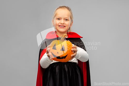 Image of girl in halloween costume of dracula with pumpkin