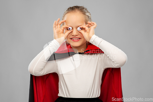 Image of girl in halloween costume of dracula with eyeballs