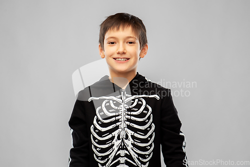 Image of boy in black halloween costume with skeleton bones