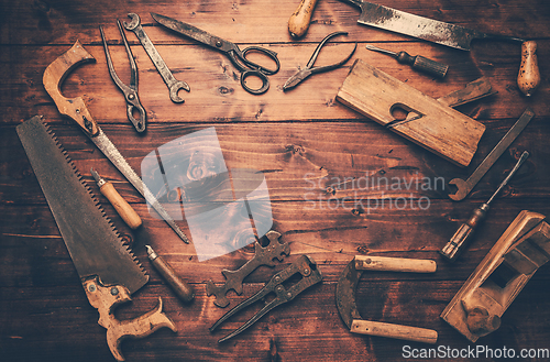 Image of Assortment of old and rusty tools in workshop.