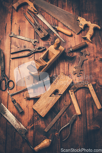 Image of Assortment of old and rusty tools in workshop.