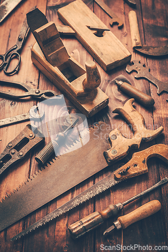 Image of Assortment of old and rusty tools in workshop.