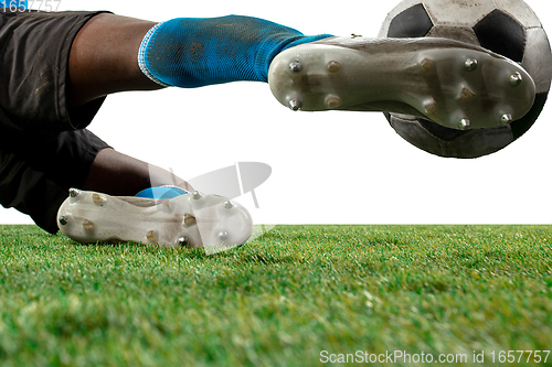 Image of Close up legs of professional soccer, football player fighting for ball on field isolated on white background