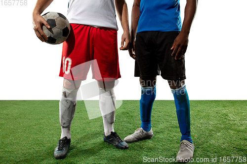 Image of Close up legs of professional soccer, football players fighting for ball on field isolated on white background