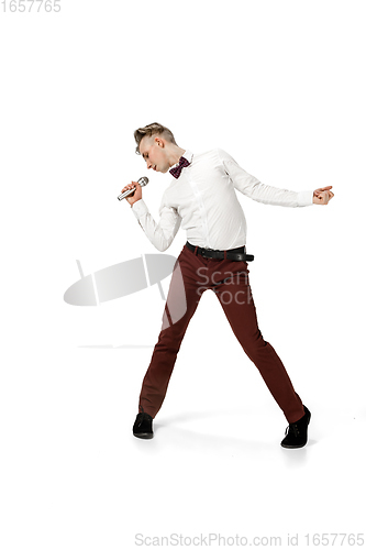 Image of Happy young man dancing in casual clothes or suit, remaking legendary moves of celebrity from culture history