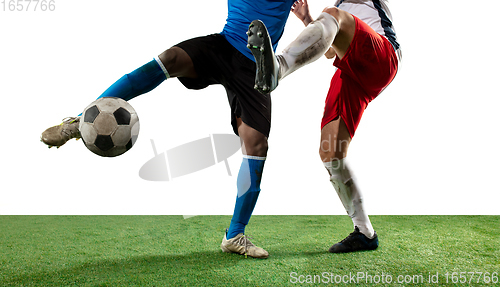 Image of Close up legs of professional soccer, football players fighting for ball on field isolated on white background