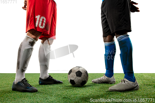 Image of Close up legs of professional soccer, football players fighting for ball on field isolated on white background