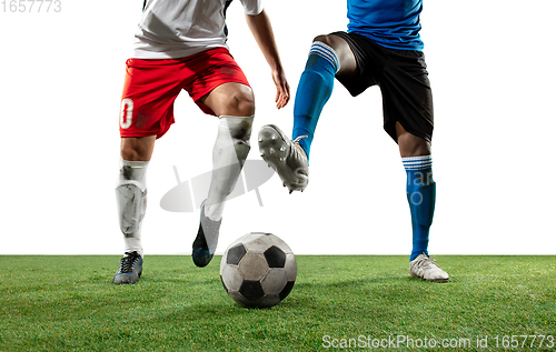 Image of Close up legs of professional soccer, football players fighting for ball on field isolated on white background