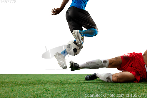 Image of Close up legs of professional soccer, football players fighting for ball on field isolated on white background