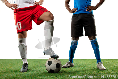 Image of Close up legs of professional soccer, football players fighting for ball on field isolated on white background