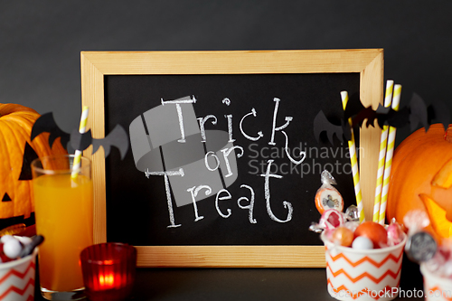 Image of pumpkins, candies and halloween decorations