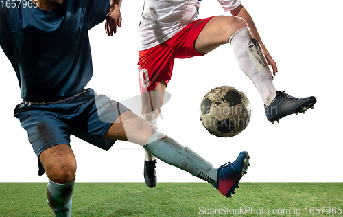 Image of Close up legs of professional soccer, football players fighting for ball on field isolated on white background