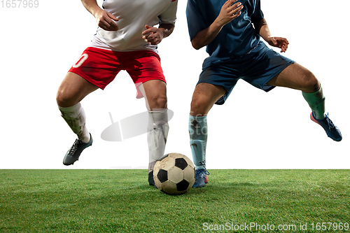 Image of Close up legs of professional soccer, football players fighting for ball on field isolated on white background