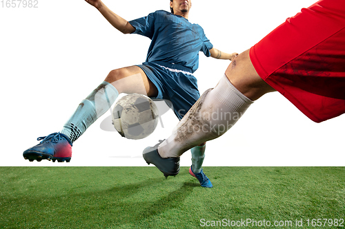 Image of Close up legs of professional soccer, football players fighting for ball on field isolated on white background