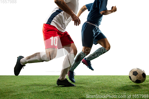 Image of Close up legs of professional soccer, football players fighting for ball on field isolated on white background