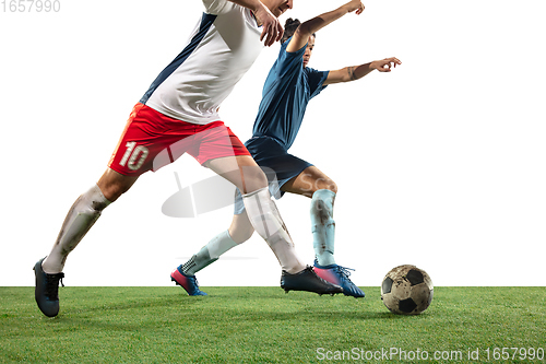 Image of Close up legs of professional soccer, football players fighting for ball on field isolated on white background