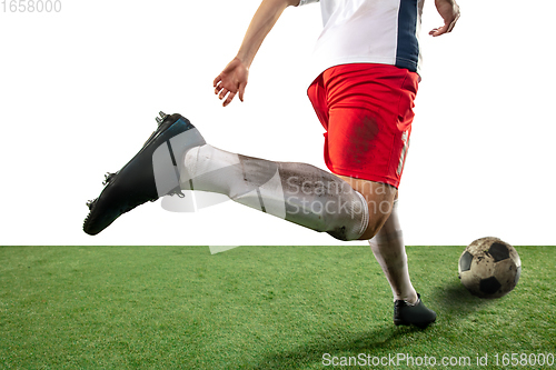 Image of Close up legs of professional soccer, football player fighting for ball on field isolated on white background