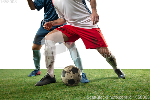 Image of Close up legs of professional soccer, football players fighting for ball on field isolated on white background