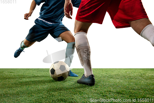 Image of Close up legs of professional soccer, football players fighting for ball on field isolated on white background