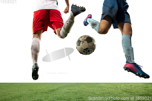 Image of Close up legs of professional soccer, football players fighting for ball on field isolated on white background