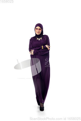 Image of Beautiful arab woman posing in stylish hijab isolated on studio background. Fashion concept