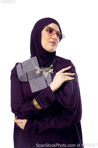 Image of Beautiful arab woman posing in stylish hijab isolated on studio background. Fashion concept