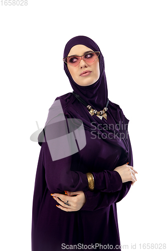 Image of Beautiful arab woman posing in stylish hijab isolated on studio background. Fashion concept