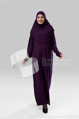 Image of Beautiful arab woman posing in stylish hijab isolated on studio background. Fashion concept