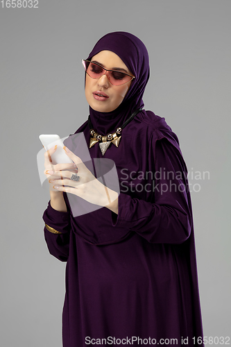 Image of Beautiful arab woman posing in stylish hijab isolated on studio background. Fashion concept