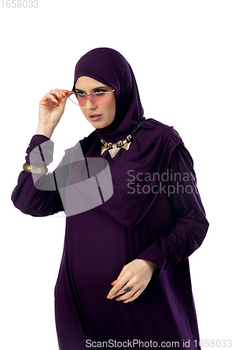 Image of Beautiful arab woman posing in stylish hijab isolated on studio background. Fashion concept