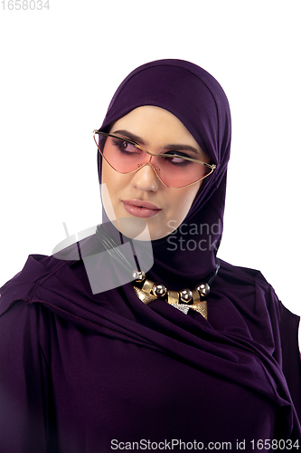 Image of Beautiful arab woman posing in stylish hijab isolated on studio background. Fashion concept