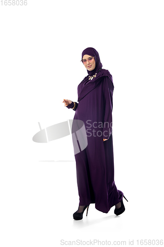 Image of Beautiful arab woman posing in stylish hijab isolated on studio background. Fashion concept