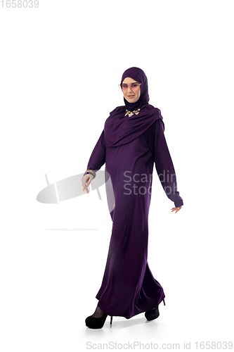 Image of Beautiful arab woman posing in stylish hijab isolated on studio background. Fashion concept