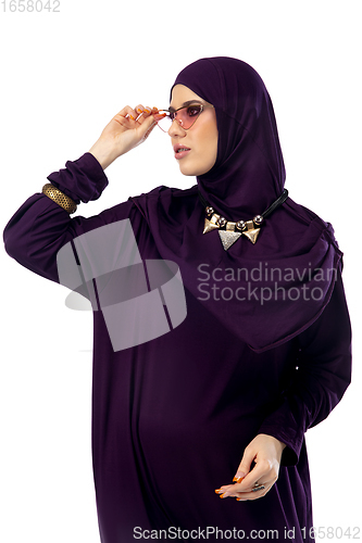 Image of Beautiful arab woman posing in stylish hijab isolated on studio background. Fashion concept