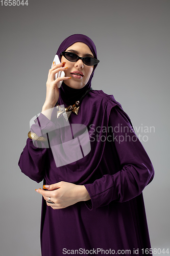 Image of Beautiful arab woman posing in stylish hijab isolated on studio background. Fashion concept