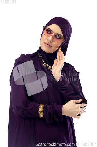 Image of Beautiful arab woman posing in stylish hijab isolated on studio background. Fashion concept