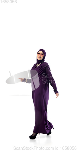 Image of Beautiful arab woman posing in stylish hijab isolated on studio background. Fashion concept