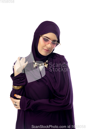 Image of Beautiful arab woman posing in stylish hijab isolated on studio background. Fashion concept