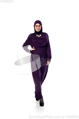 Image of Beautiful arab woman posing in stylish hijab isolated on studio background. Fashion concept