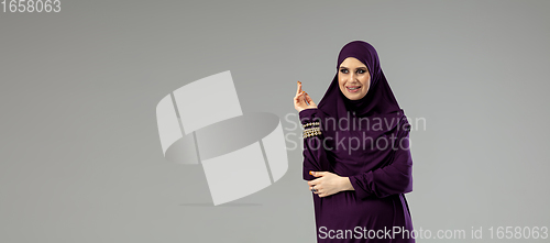 Image of Beautiful arab woman posing in stylish hijab isolated on studio background. Fashion concept