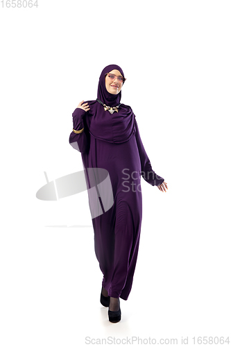 Image of Beautiful arab woman posing in stylish hijab isolated on studio background. Fashion concept