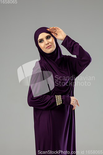 Image of Beautiful arab woman posing in stylish hijab isolated on studio background. Fashion concept