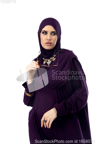 Image of Beautiful arab woman posing in stylish hijab isolated on studio background. Fashion concept