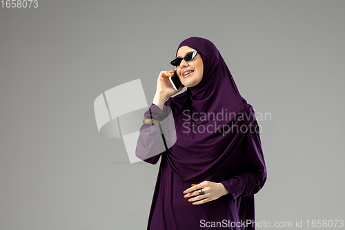Image of Beautiful arab woman posing in stylish hijab isolated on studio background. Fashion concept