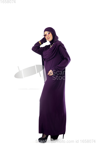 Image of Beautiful arab woman posing in stylish hijab isolated on studio background. Fashion concept