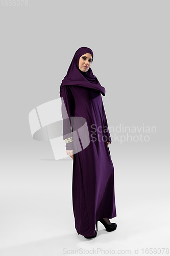 Image of Beautiful arab woman posing in stylish hijab isolated on studio background. Fashion concept