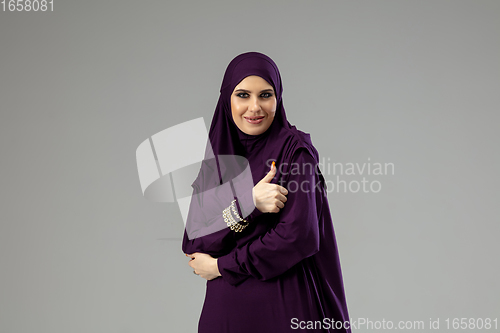 Image of Beautiful arab woman posing in stylish hijab isolated on studio background. Fashion concept