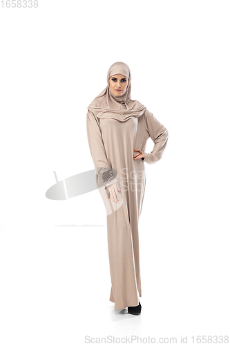 Image of Beautiful arab woman posing in stylish hijab isolated on studio background. Fashion concept