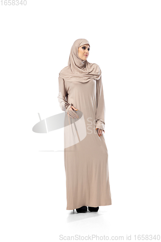 Image of Beautiful arab woman posing in stylish hijab isolated on studio background. Fashion concept