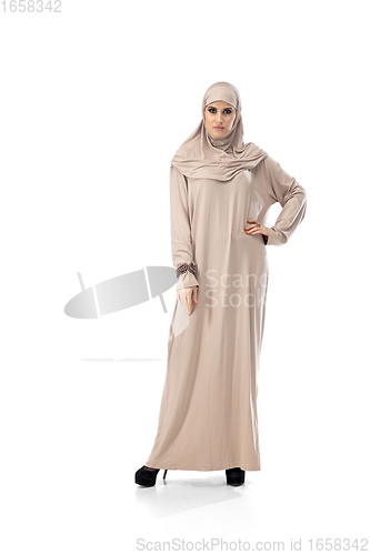 Image of Beautiful arab woman posing in stylish hijab isolated on studio background. Fashion concept
